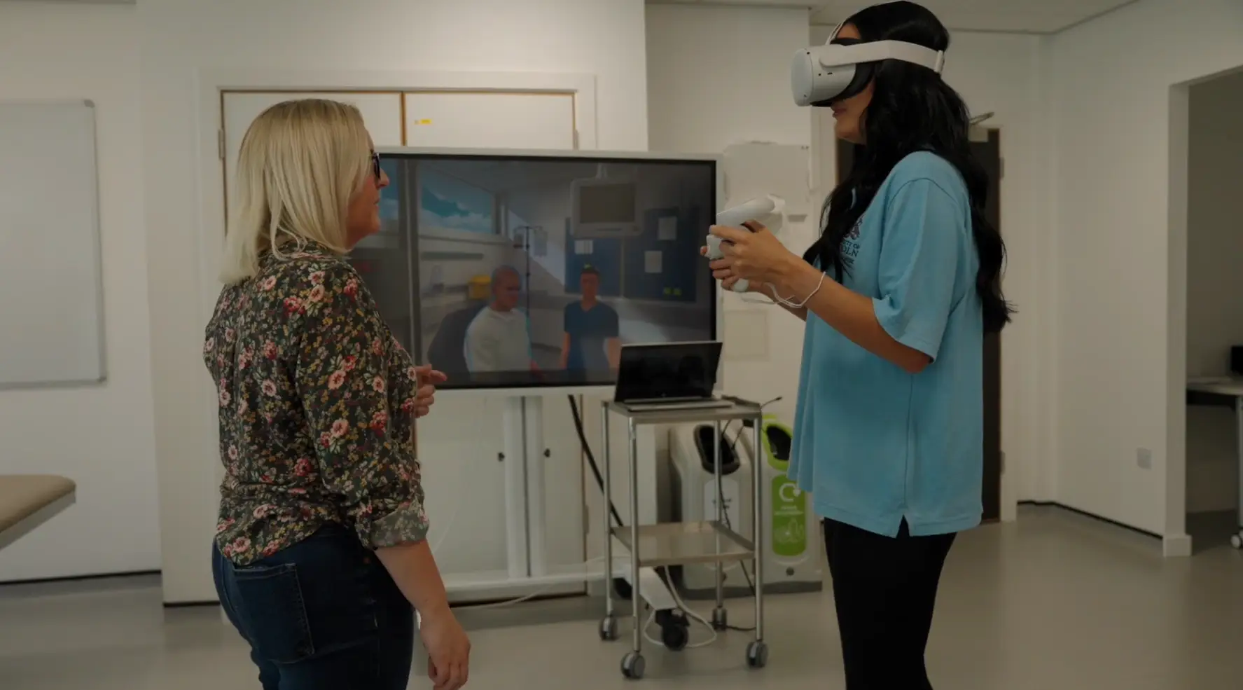 Educator working with nursing student in VR headset