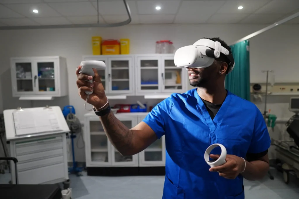 Instructor using a VR headset to lead an OMS VR medical training laboratory.