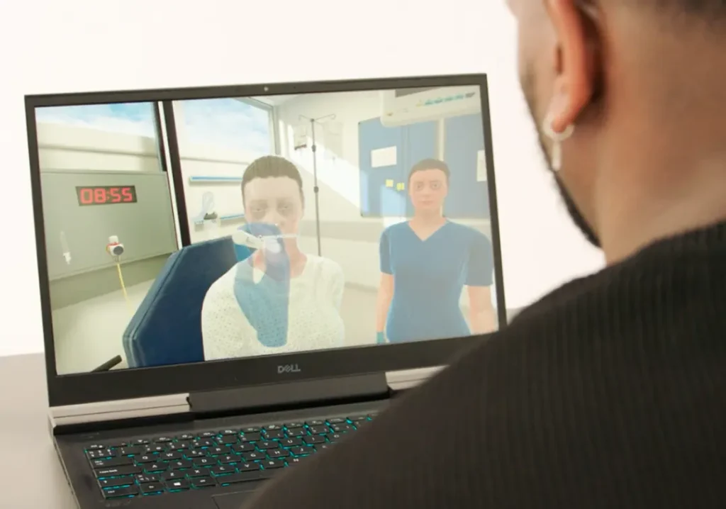 Instructor reviewing learner metrics on a screen during OMS VR medical training.
