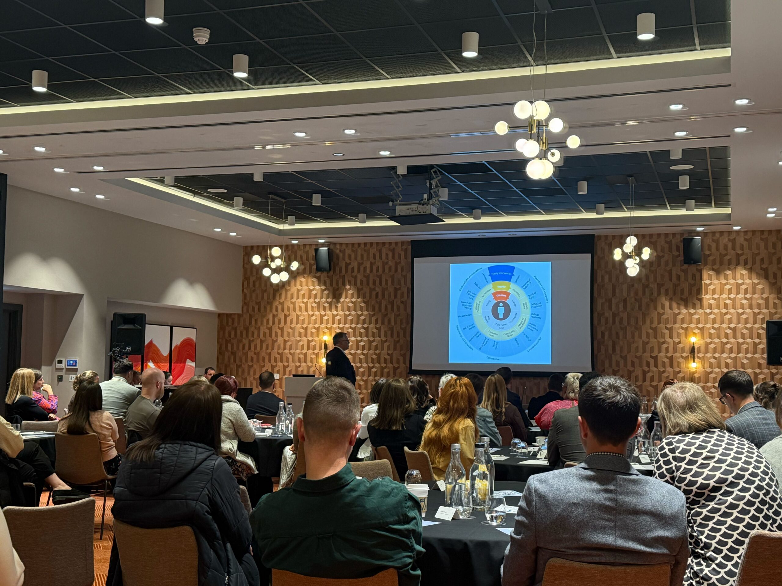 Audience and speaker during OMS Clinical Readiness Summit